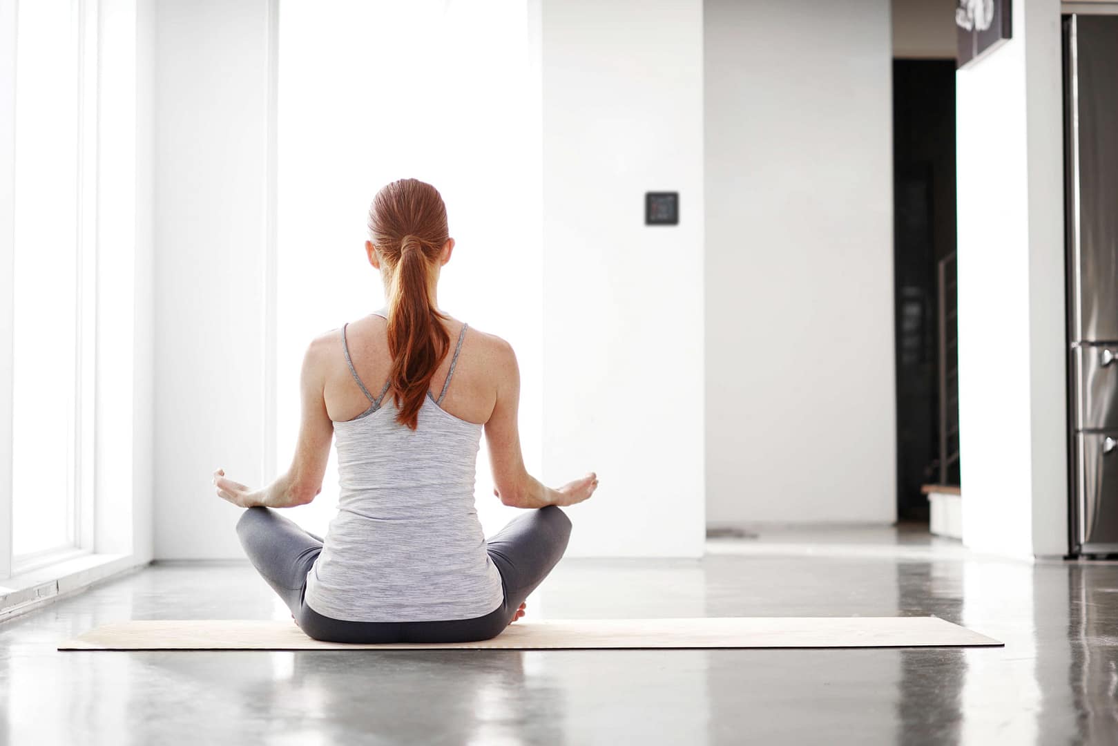 Woman relaxing in a clean, comfortable home with improved indoor air quality from an HVAC system